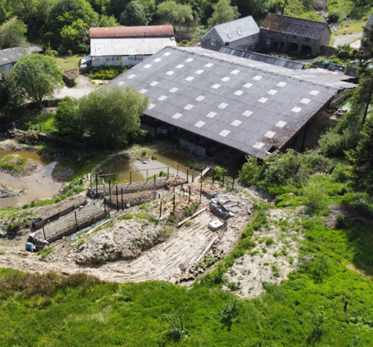 Aerial photo of the smallholding with house, barns, and surrounding land